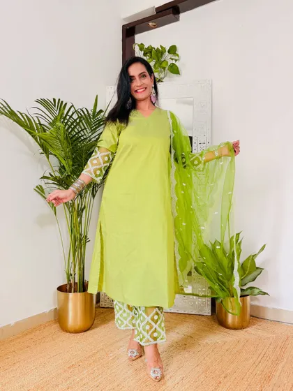 This lime green suit set is so fresh and vibrant. It's a great color for a daytime event or festival, and the printed pants add a fun touch.