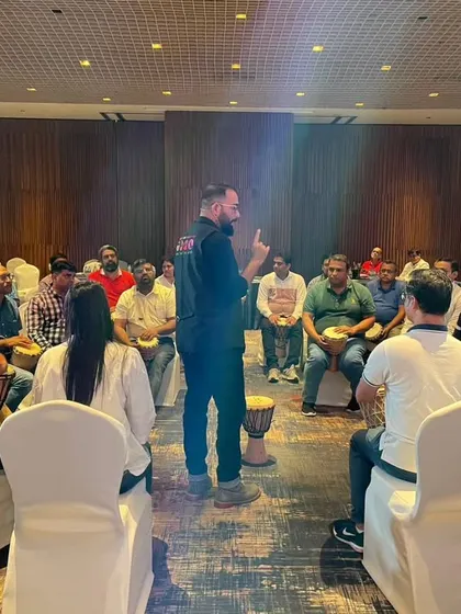 A facilitator explains a concept during a corporate session. It's not just about playing; it's about learning metaphors for leadership, listening, and collaboration that teams can take back to the workplace.