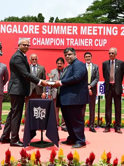 Mr. Sulaiman S. Attaollahi presents The Champion Trainer Cup to the connections of Tolkien, honoring a great training performance.