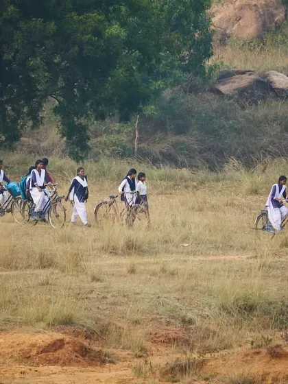 A duplicate of 137, this image captures the rustic charm and determination of the girls on their way to the climbing session.