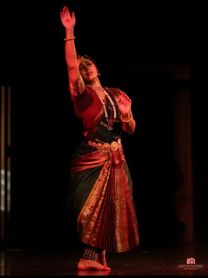 The verticality and reach in this pose create a sense of aspiration and devotion, a common theme in the classical repertoire.