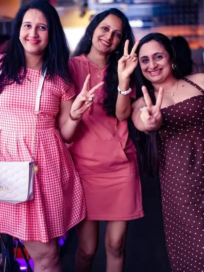 A group of friends making the peace sign, capturing the fun and friendly vibe of the party.