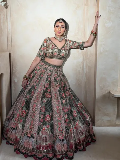 Another stunning view of the floral lehenga. The pose highlights the beautiful fall of the skirt and the intricate details of the blouse.