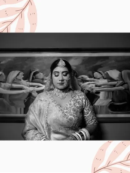 An artistic black and white portrait of the bride standing in front of a painting, creating a thoughtful and layered composition.