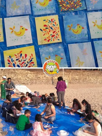 The beautiful results of our beach painting session. The colorful artwork displayed on the blue tarp shows the collective creativity of the group.