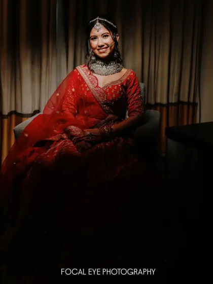 A dramatic, low-key portrait of a bride in red, with the light focused just on her. This creates a moody, cinematic, and powerful image.