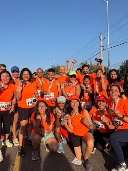 The joy of the finish line. A large group of our runners celebrating their achievement at the Honda Manesar Half Marathon.