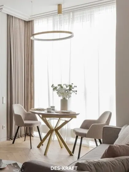 This shot highlights the intimate dining nook, perfectly positioned by the window to take advantage of natural light. The modern ring chandelier adds a sculptural element.