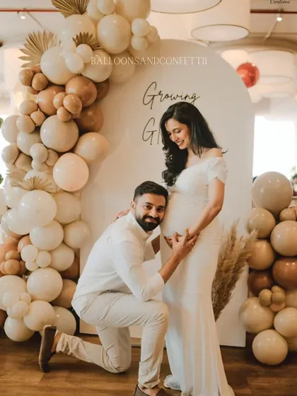 A beautiful moment captured. The parents-to-be are glowing in front of the 'Growing & Glowing' backdrop I designed for their baby shower.