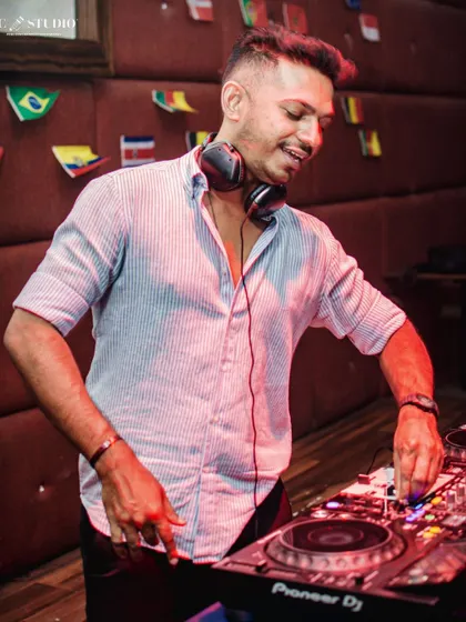 A candid shot of me enjoying the moment, mixing tracks with a smile. This is more than a job, it's my passion.