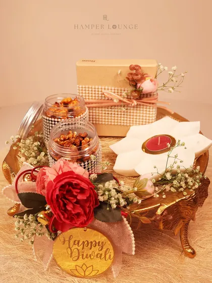 A clean, beautiful shot of my golden elephant tray Diwali hamper. It showcases the premium dry fruit jars, the lotus-shaped candle, and the floral decorations, highlighting the festive elegance of the arrangement.