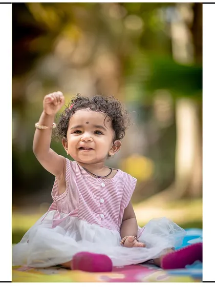 A triumphant and happy gesture captured on camera. These energetic moments are what make toddler photography so much fun.