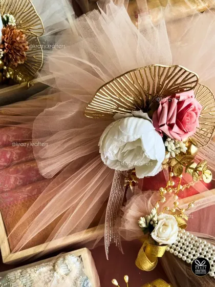 For me, trousseau packaging is an art. I combine elegant details like pastel net, artificial peonies and roses, and touches of gold to create a luxurious wrap for your wedding gifts that feels as special as the day itself.