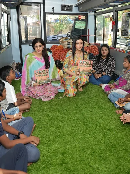We, the co-founders, reading our book 'Jungle Jugalbandi' to an attentive group of children on the bus.
