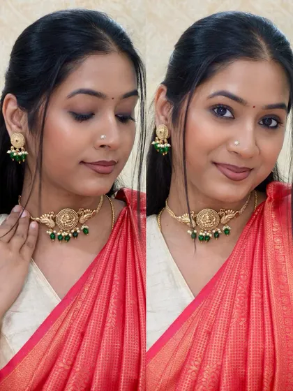 A traditional temple jewelry choker with green beads, paired with a bright red saree. A classic and gorgeous combination.