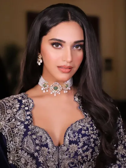 A close-up portrait of the midnight blue Jayanti Reddy look. The model's soft makeup and the elegant choker allow the detailed craftsmanship of the blouse to take center stage.