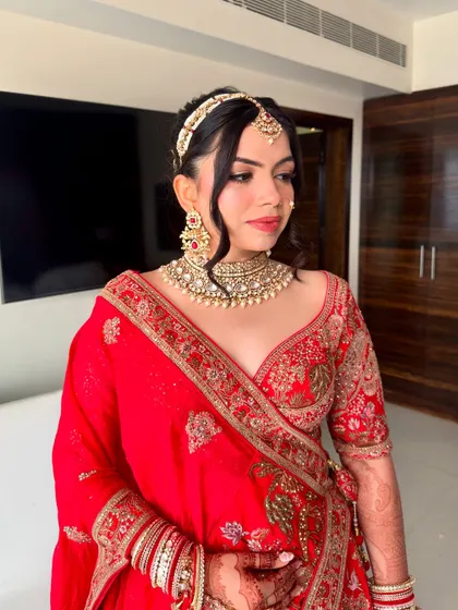 The side profile highlights the clean lines of the makeup and the intricate hairstyle.