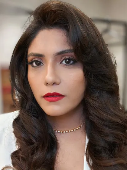 A direct, confident gaze. The classic red lip and clean eyeliner make a powerful statement, perfect for a cocktail party.
