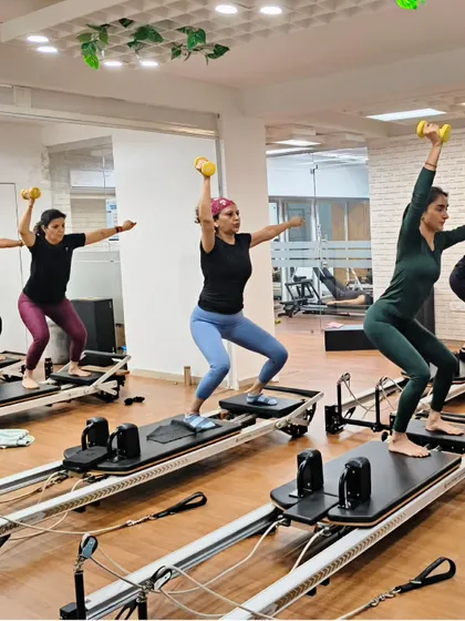 Various shots of members and instructors in action during our dynamic Reformer Pilates classes.