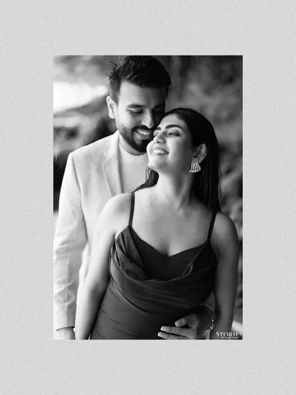 A beautiful black and white portrait that highlights the bride-to-be's happy expression and the couple's gentle embrace.