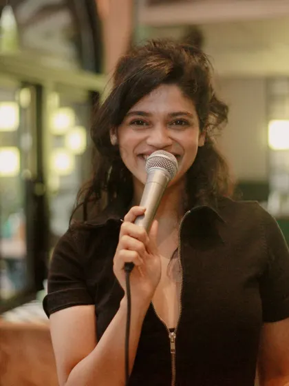 A happy moment captured during a karaoke night at Daysie on MG Road. The warm lighting and cozy setup make it a great spot for singing your heart out.