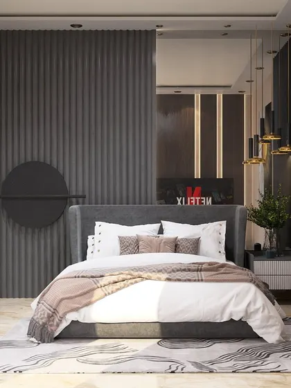 This bedroom is a tribute to the elegance of grey. A fluted wall panel serves as a dramatic headboard, complemented by a grey upholstered bed and a large tinted mirror that adds depth to the room.