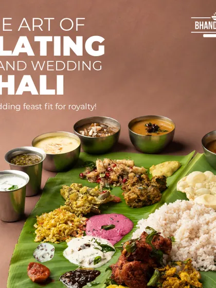 The art of plating a grand wedding thali on a traditional banana leaf. This is a feast fit for royalty, showcasing a wide array of authentic South Indian dishes, each with its unique flavor and texture.