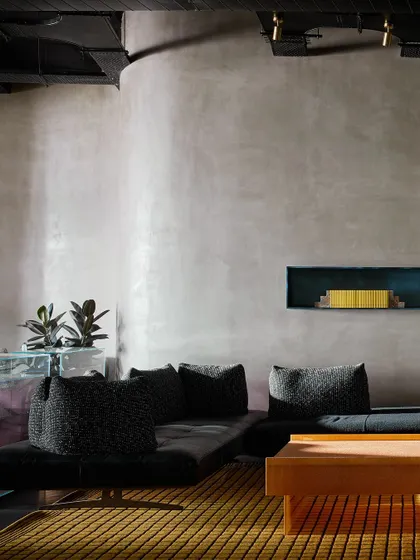 The minimalist side of the striped wall vignette, where a simple grey textured wall provides a calm counterpoint to the bold pattern.