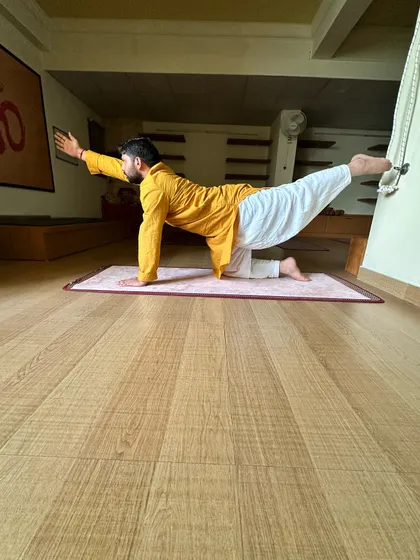 The Vyaghrasana (Tiger Pose) variation is excellent for strengthening the back and core muscles, which is essential for spinal health.