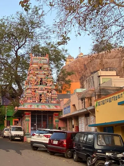 A view of a temple with the Rock Fort in the background. The layering of history, topography, and architecture in a single frame is a constant source of inspiration for creating contextually rich designs.