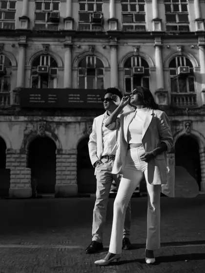 A striking black and white photo of the couple in the city. The high contrast and strong composition make this a powerful image.