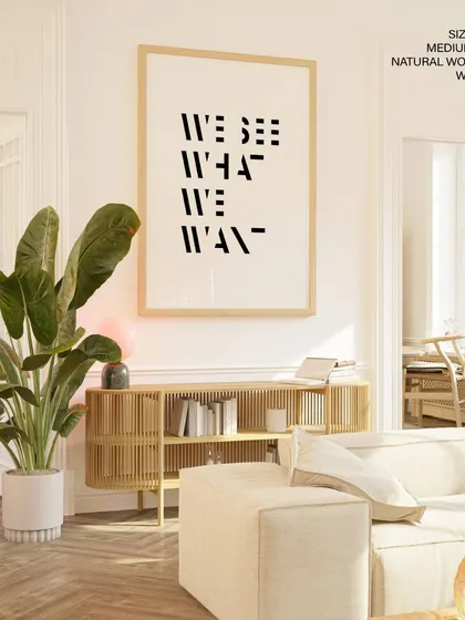 A thought-provoking typographic print that reads "We See What We Want." The distorted, modern font adds an artistic layer to the message, making it a great conversation starter.