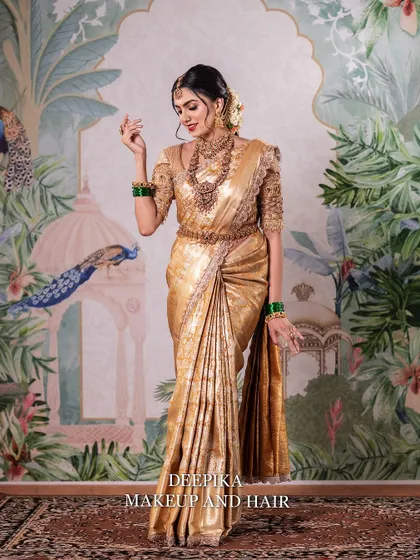 A full-length shot capturing the graceful movement of the saree. The bride looks ethereal against the beautifully painted backdrop.