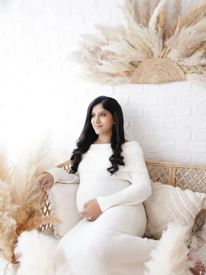A duplicate of image 252, this simple and sweet announcement photo with a "Baby is coming 2025" sign is captured in a soft and dreamy light.