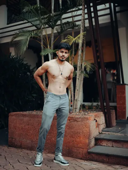 A shirtless outdoor shot, showing a lean and aesthetic physique.