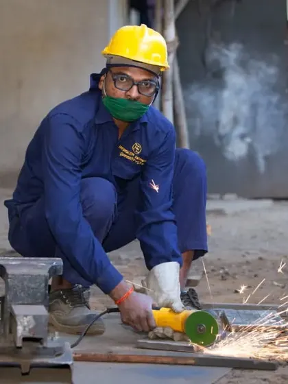 This action shot was taken during an industrial photography project at a manufacturing facility. Capturing the sparks from the angle grinder adds a dynamic element that documents the authentic, hands-on work happening on the factory floor.