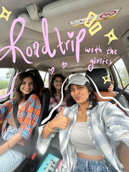 A group selfie in the car, transformed into a scrapbook memory with "Road trip with the girlies" written in cute script.