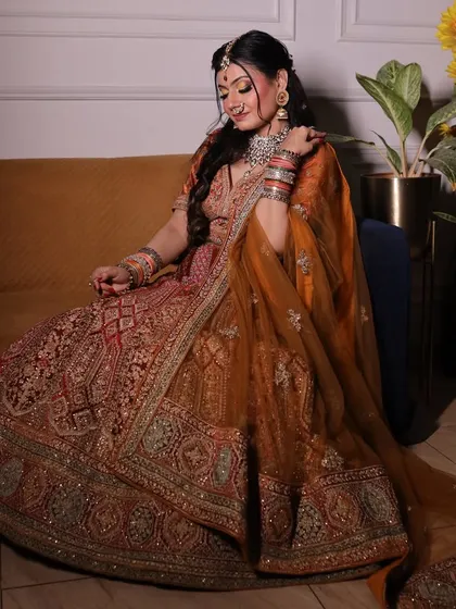 A full view of the rust-orange bridal lehenga and jewellery set. You can see how the entire ensemble comes together, offering a complete rental solution for brides.