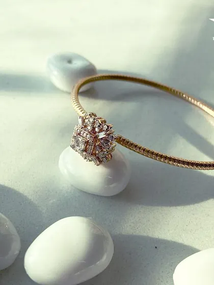 This minimalist gold bracelet with a central diamond cluster is the perfect finishing touch that uplifts your look, making you feel effortlessly chic.