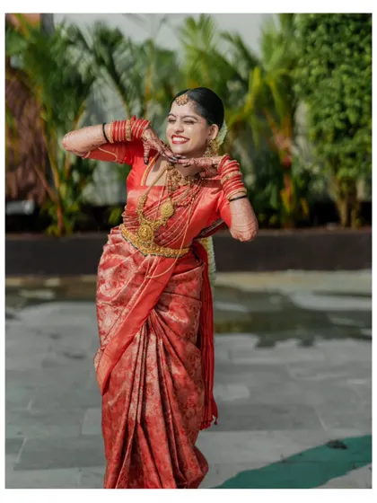 A playful and cute portrait of a bride making a heart shape with her hands, full of personality and joy.