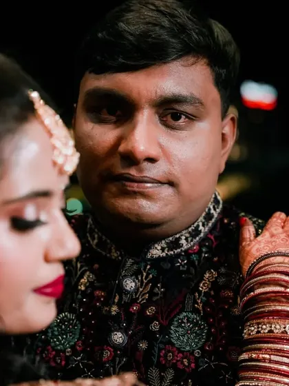 A close-up portrait focusing on the couple's connection. The way the bride rests her hand on the groom's shoulder shows their comfort and love.