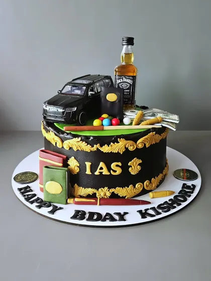 For an IAS aspirant! This rum-infused chocolate truffle cake is loaded with all his favorite things: a car, Jack Daniels, books, and snooker balls.