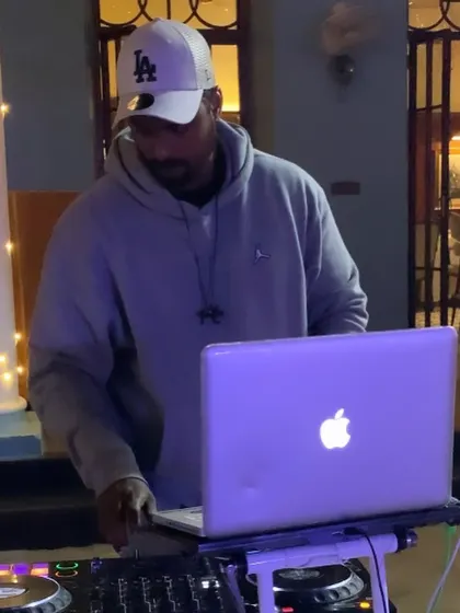 Checking my playlist on the laptop to line up the next sequence of tracks.