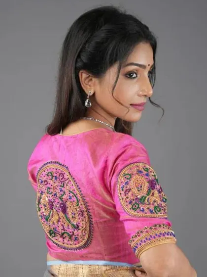 The back of this pink blouse is a work of art, with two beautifully embroidered peacock motifs.