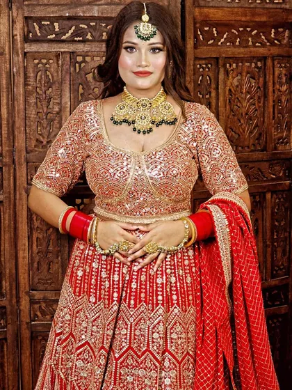 A frontal view of the gold and green Kundan choker set, showing how it beautifully frames the neckline of the bridal blouse.