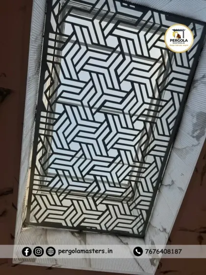 A close-up view of a geometric patterned skylight. The bold, black framework creates a striking contrast against the sky, turning the ceiling into a modern design statement while illuminating the space below.