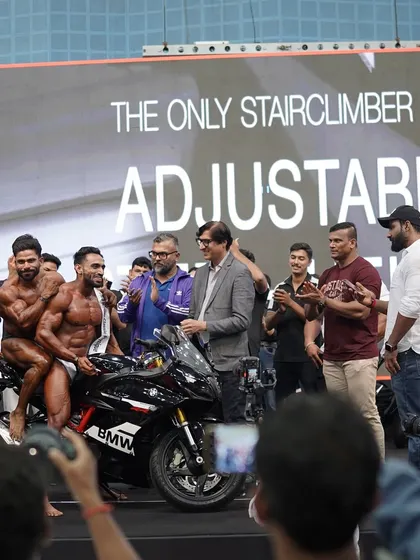 On stage, receiving the prize. Every rep in the gym, every clean meal, it all leads to moments like this. This is the result of a focused muscle gain program.