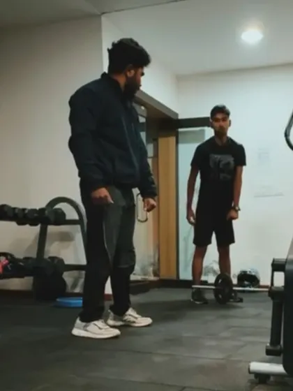 Another moment from a home training session. Here, I'm instructing a client on the proper form for a deadlift with a light barbell, proving you can build strength anywhere.