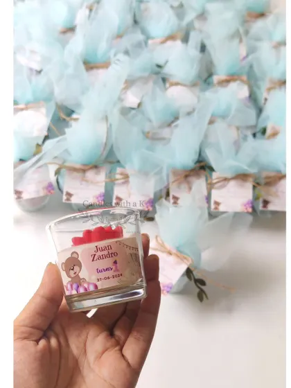 Holding one of the personalized votive candles for Juan Zandro's first birthday.