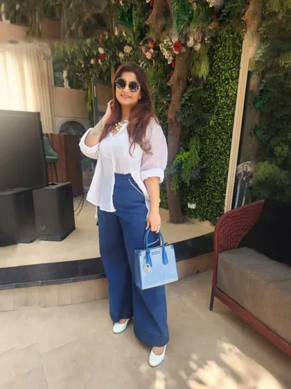 A timeless classic with a twist. A simple white shirt with unique off-shoulder cuts paired with wide-leg denim for a fresh, effortlessly chic look.